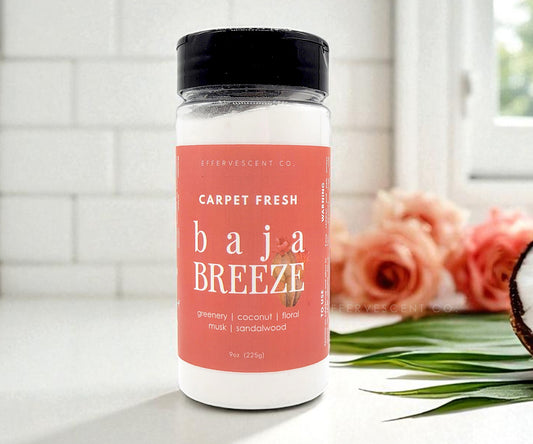 Bottle of 'Carpet Fresh Baja Breeze' with a pink label on a kitchen counter.