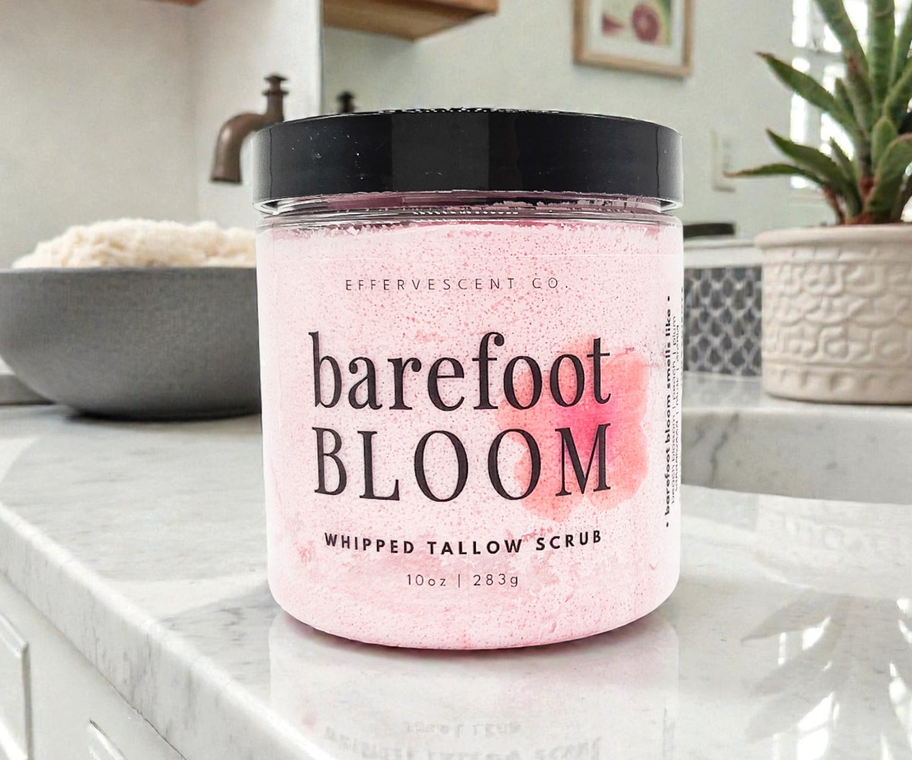 Jar of 'barefoot BLOOM' whipped tallow scrub on a kitchen counter