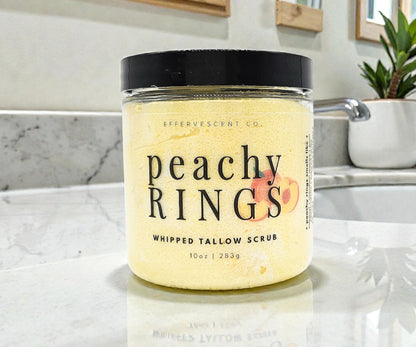 Jar of 'Peachy Rings' whipped tallow scrub on a bathroom counter